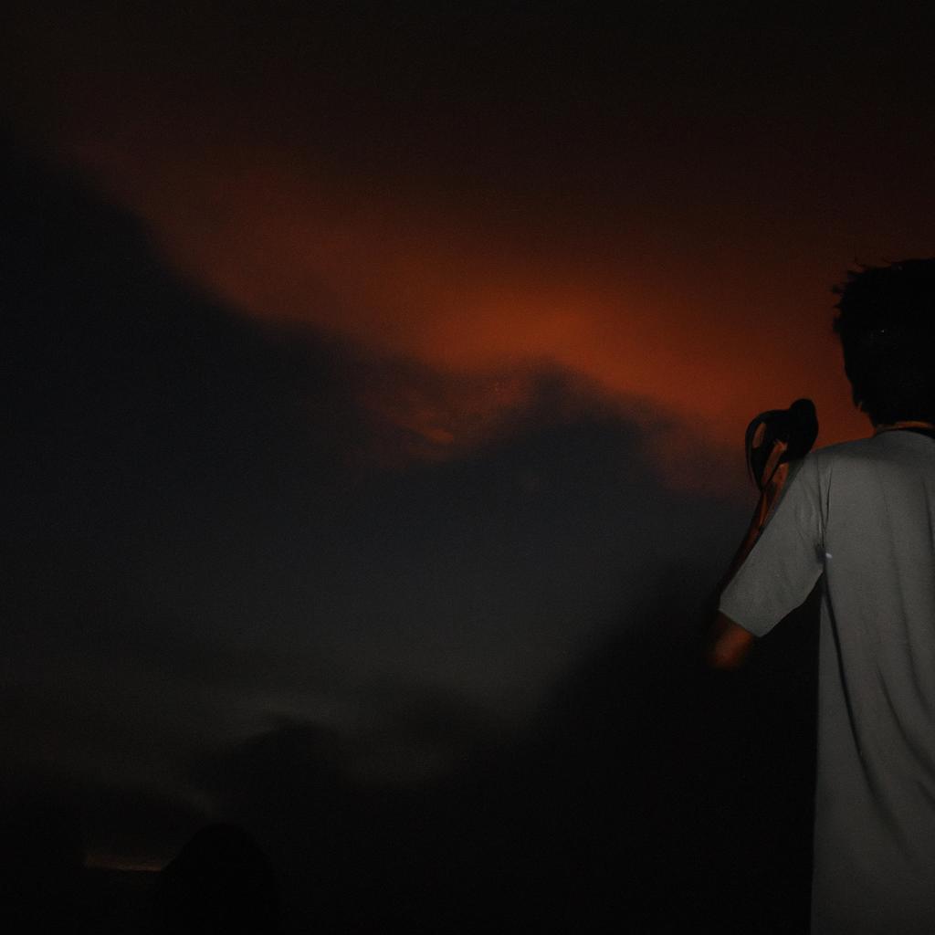 Person taking silhouette photographs at night
